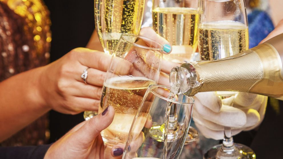 People participate in a New Year's toast in this stock image.