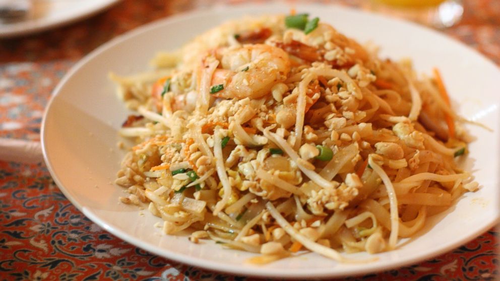 Pad Thai with seafood and peanuts is visible in this stock image.