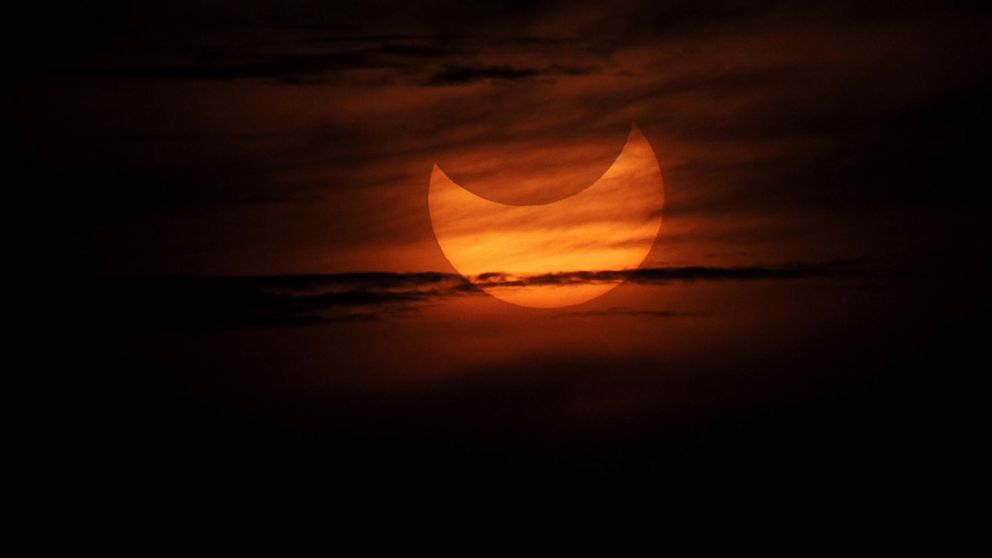 A partial solar eclipse as seen during sunrise in the coastal town of Gumaca, Philippines, May 21, 2012.
