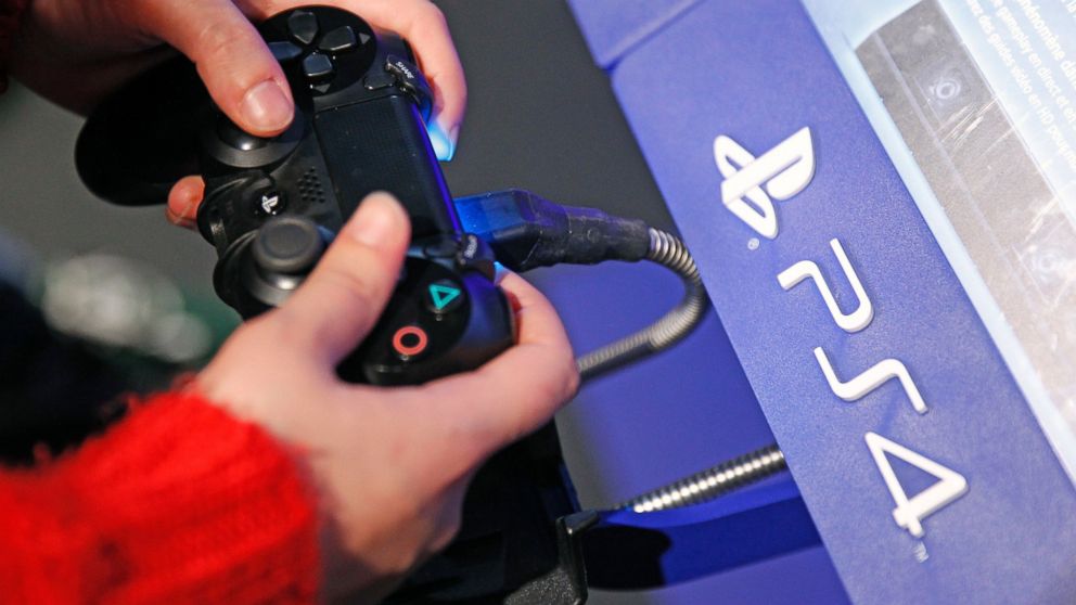 A visitor plays on Sony Playstation 4 video game console (PS4), produced by Sony Corporation, during the &quot;Noel de Geek,&quot; Dec. 23, 2014, in Paris.