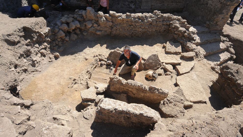 French archaeologist Henri Duday of National Center for Scientific Research (CNRS), shows a Samnite tomb of the fourth century BC. with a woman's skeleton and many amphoras discovered inside ancient ruins of Pompeii during a press conference on Sept. 21, 2015. 