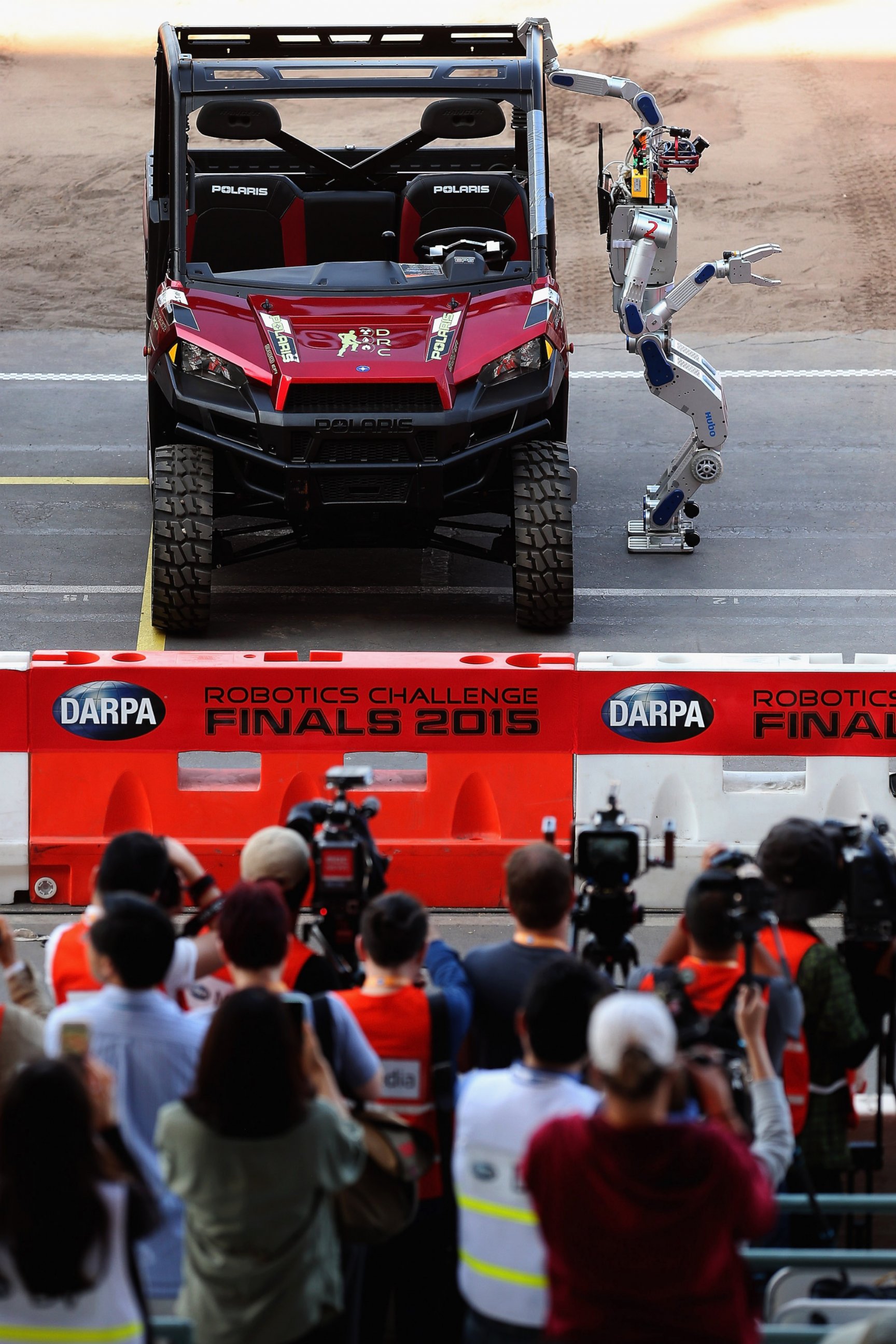 PHOTO: The Team Kaist HUBO robot from South Korea climbs out of a Polairs vehicle during the first day of the Defense Advanced Research Projects Agency (DARPA) Robotics Challenge at the Fairplex, June 5, 2015, in Pomona, Calif. 