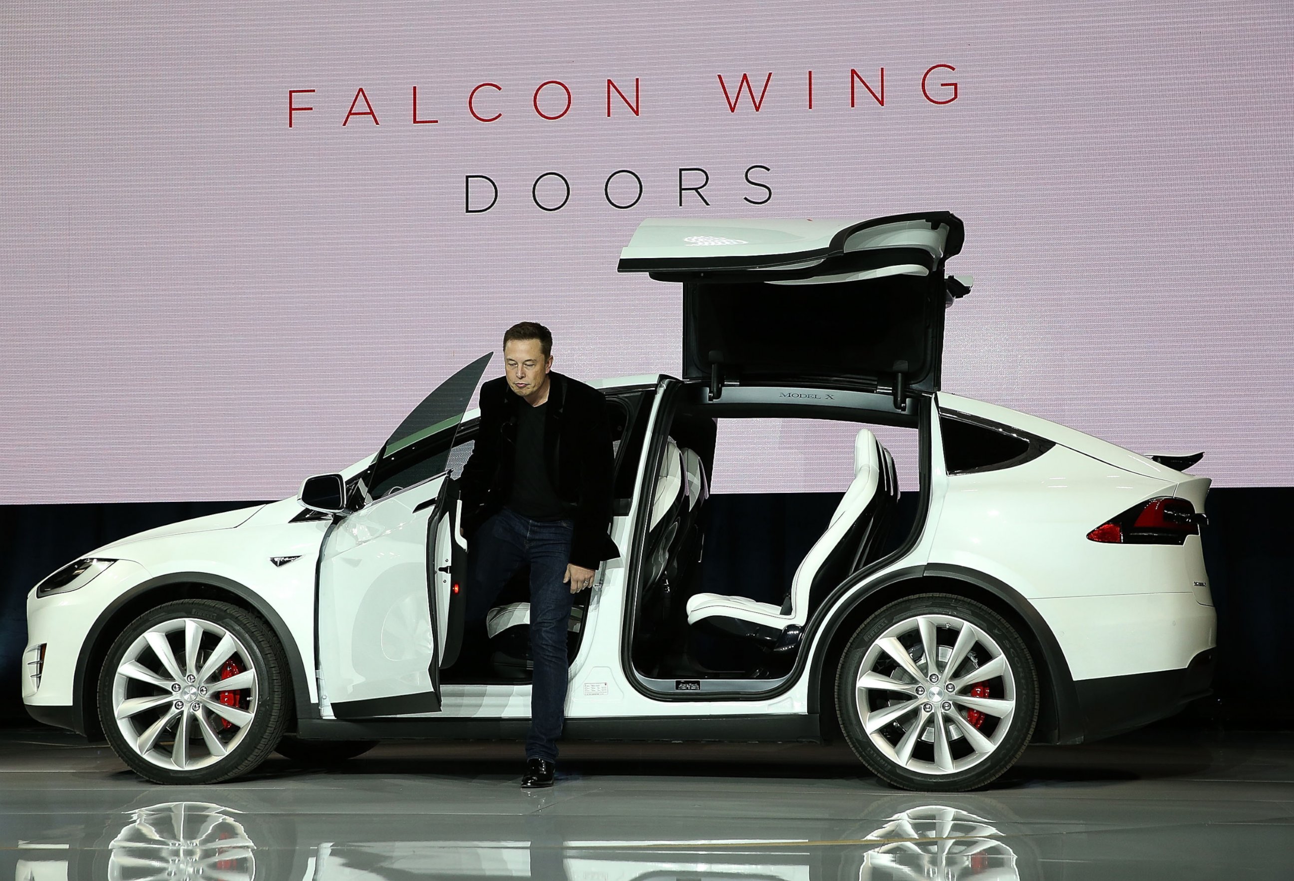 PHOTO: Elon Musk demonstrates the falcon wing doors on the new Tesla Model X Crossover SUV during a launch event on Sep. 29, 2015 in Fremont, California.