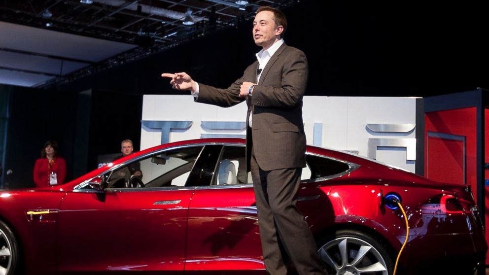Elon Musk is pictured speaking in front of a Tesla Model S in Detroit, Mich. on Jan. 12, 2010.
