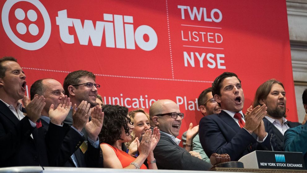 Twilio Inc. founder and CEO Jeff Lawson, center, reacts after ringing the opening bell to celebrate Twilio's initial public offering, at the New York Stock Exchange, June 23, 2016 in New York.