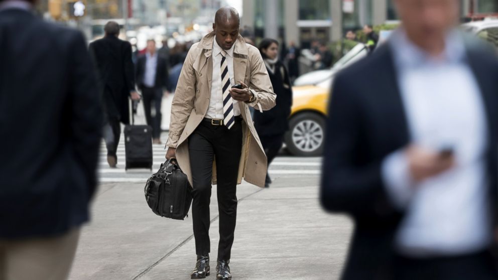PHOTO: People walk and text while crossing the street.
