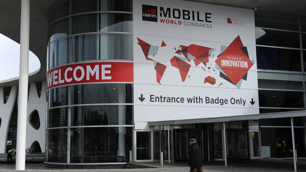 A person walks past a building entrance during final preparations for Mobile World congress in Barcelona, Feb. 25, 2015.