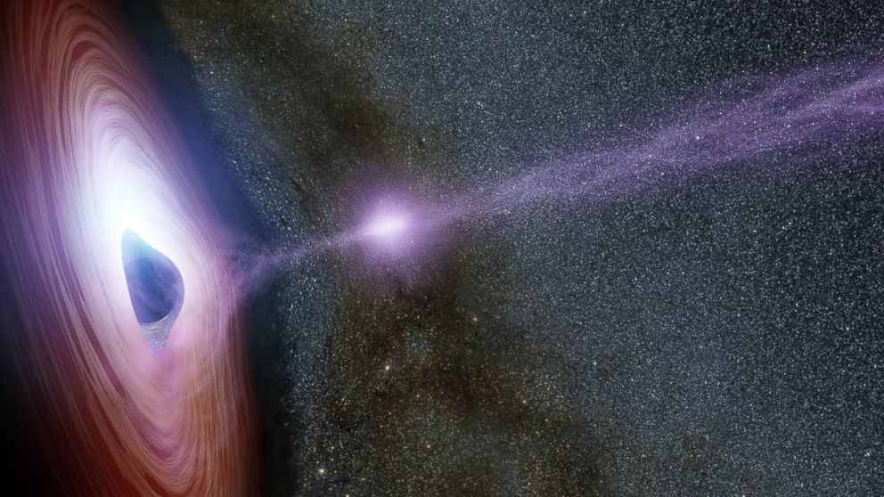 A supermassive black hole is depicted in this artist's concept, surrounded by a swirling disk of material falling onto it. The purplish ball of light above the black hole, a feature called the corona, contains highly energetic particles that generate X-ray light.