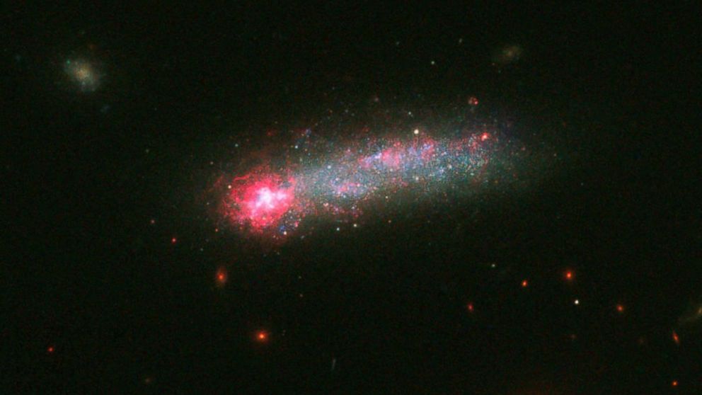 A photo released on June 28, 2016 by the NASA/ESA Hubble Space Telescope, shows a fireworks show in a galaxy 82 million light years away from Earth.

