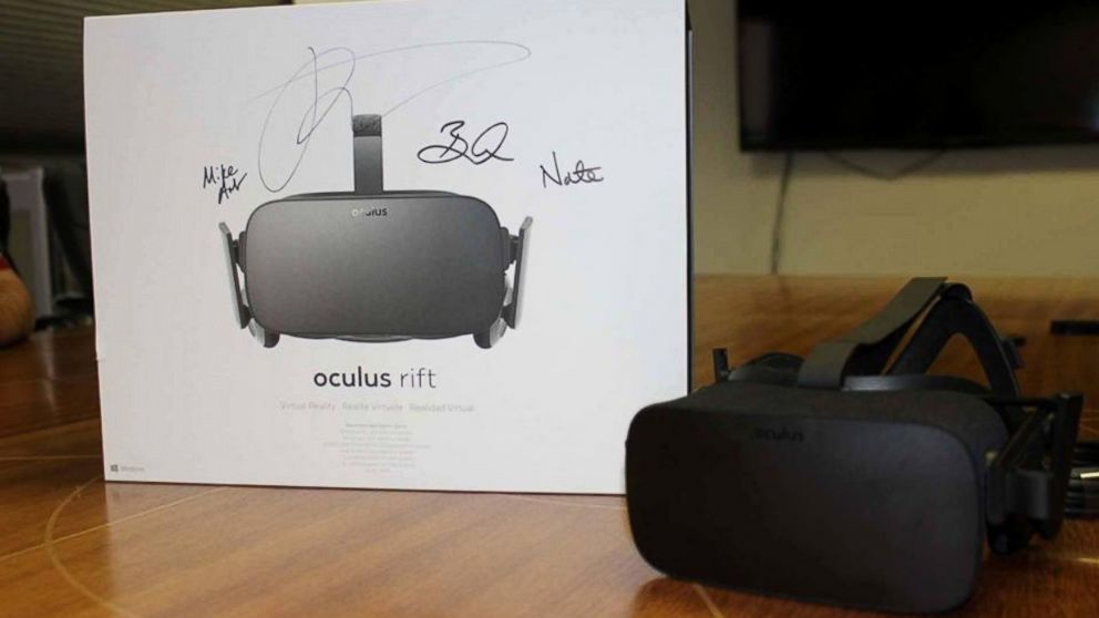PHOTO: Palmer Luckey, the founder of Oculus, hand delivered a headset to Ross, an indie developer, who was the first person to pre-order the headset.