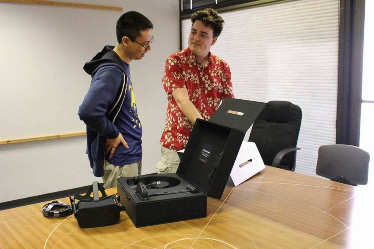 PHOTO: Palmer Luckey, the founder of Oculus, hand delivered a headset to Ross, an indie developer, who was the first person to pre-order the headset.