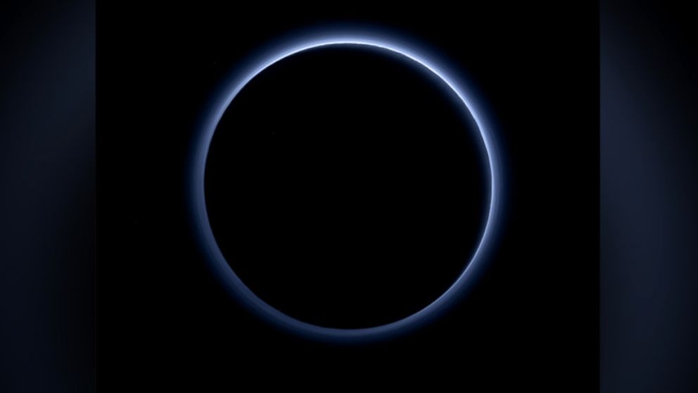 Pluto's Blue Sky: Pluto's haze layer shows its blue color in this picture taken by the New Horizons Ralph/Multispectral Visible Imaging Camera (MVIC). The high-altitude haze is thought to be similar in nature to that seen at Saturn's moon Titan. The source of both hazes likely involves sunlight-initiated chemical reactions of nitrogen and methane, leading to relatively small, soot-like particles (called tholins) that grow as they settle toward the surface. 