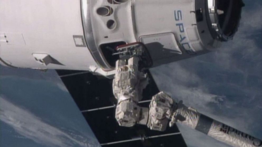 A robotic arm from the International Space Station attaches to the SpaceX Dragon capsule, Jan. 12, 2015.