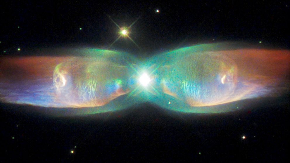 The shimmering colors visible in this NASA/ESA Hubble Space Telescope image show off the remarkable complexity of the Twin Jet Nebula.