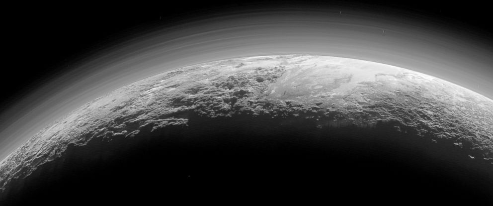 PHOTO: Pluto’s Majestic Mountains, Frozen Plains and Foggy Hazes: Just 15 minutes after its closest approach to Pluto on July 14, 2015.
