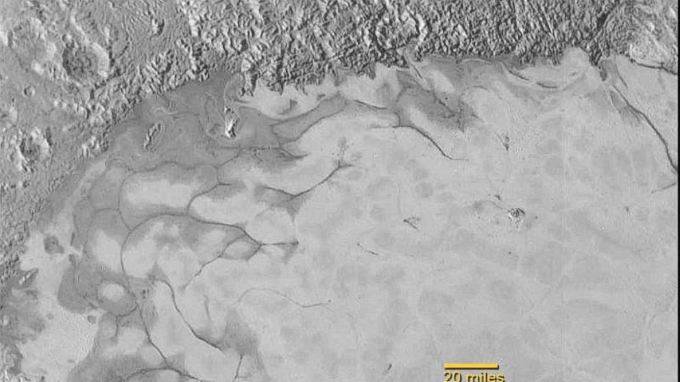 PHOTO: NASA’s New Horizons mission has found evidence of exotic ices flowing across Pluto’s surface, at the left edge of its bright heart-shaped area.