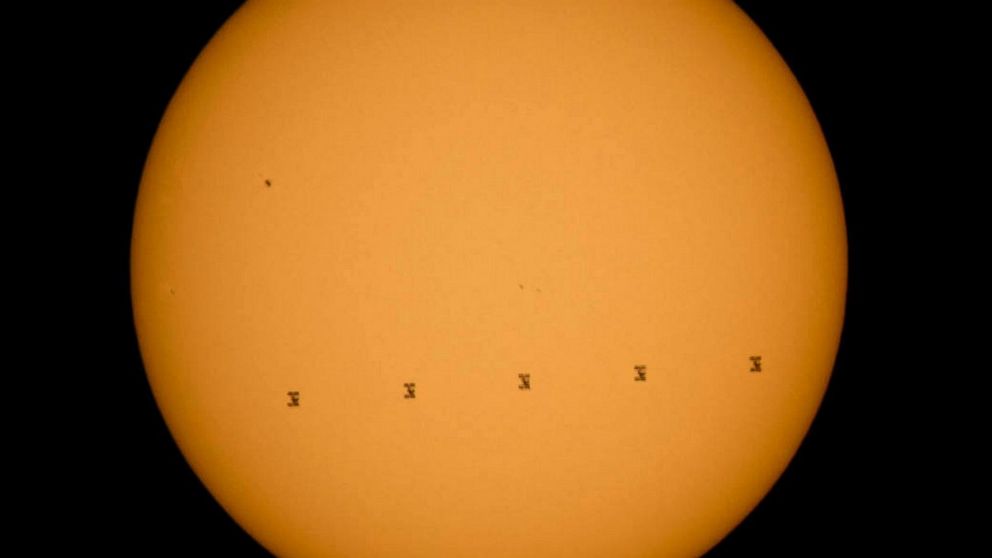 This composite image made from five frames shows the International Space Station, with a crew of nine onboard, in silhouette as it transits the sun at roughly five miles per second, Sept. 6, 2015, Shenandoah National Park, Front Royal, Va. 