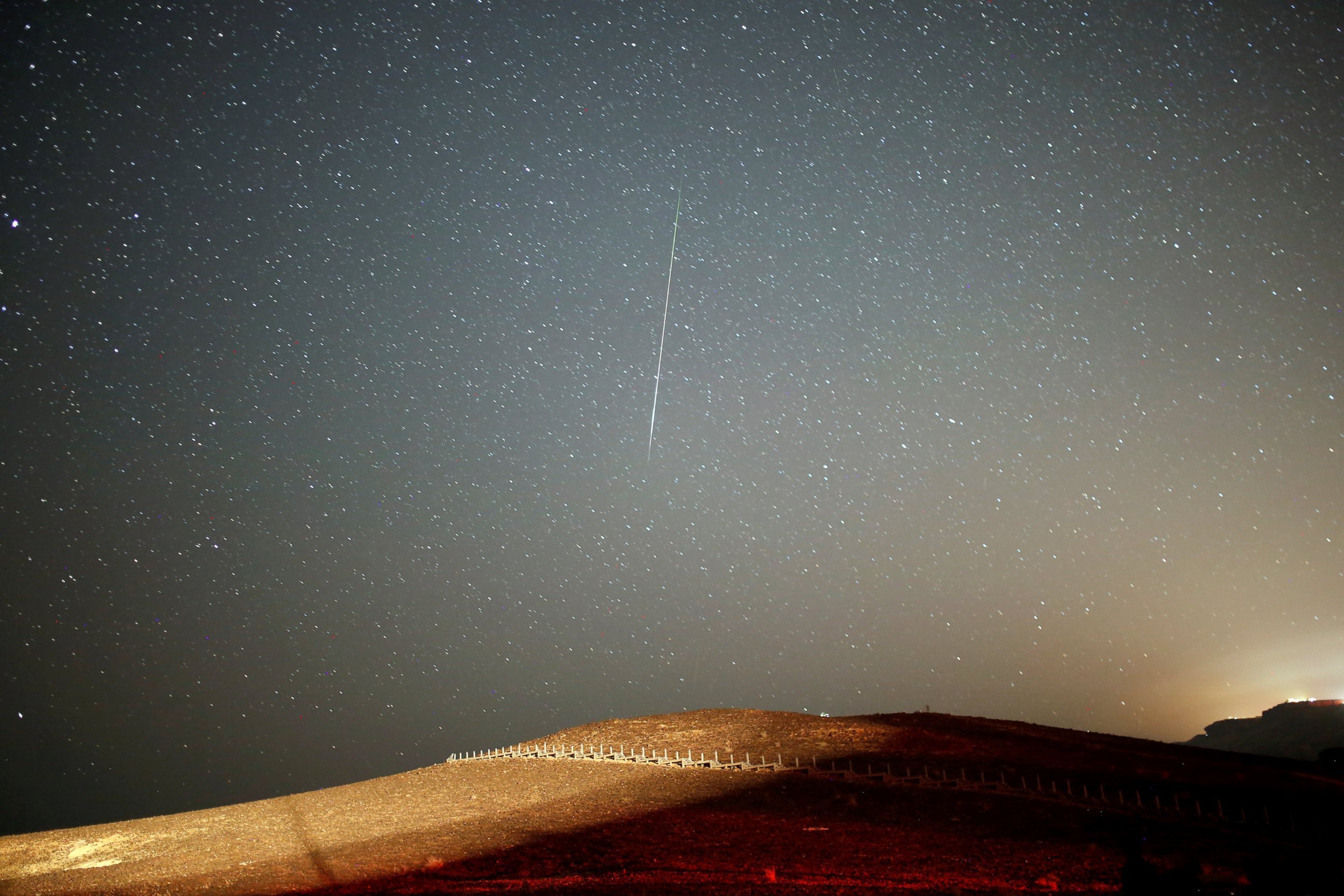 PHOTO: A meteor streaks across the sky in the early morning during the Perseid meteor shower in Ramon Crater near the town of Mitzpe Ramon, Israel, Aug.12, 2016.