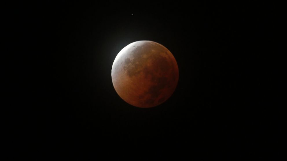 The moon is seen during a total lunar eclipse, which makes the moon appear red, over Chosica on the outskirts of Lima, Puru,  April 15, 2014.