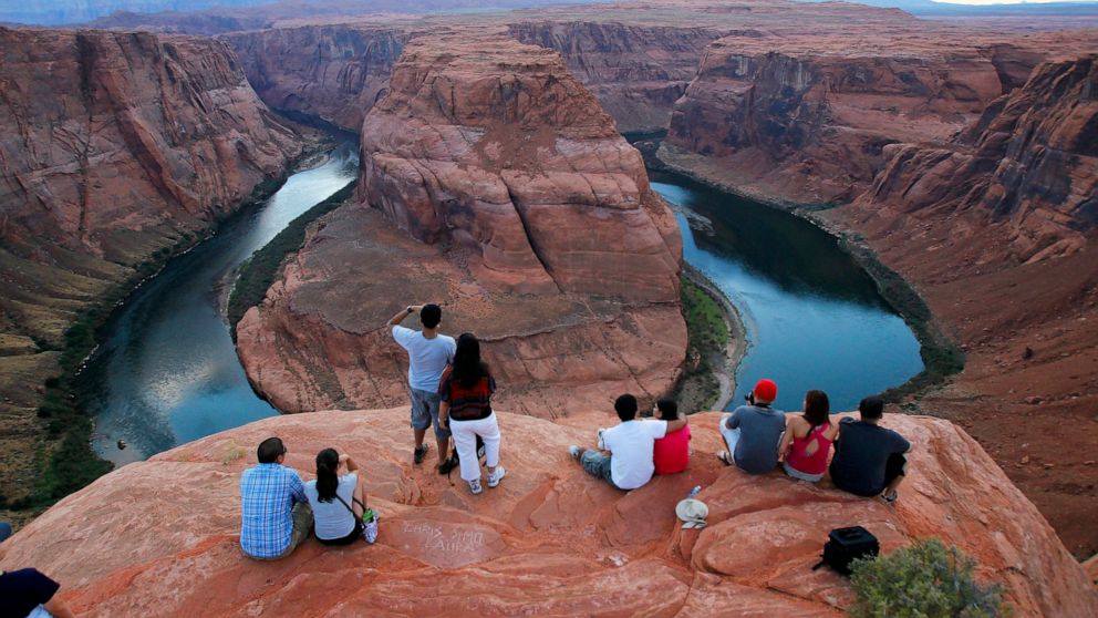 FILE - Visitors view the dramatic bend in the Colorado River at the popular Horseshoe Bend in Glen Canyon National Recreation Area, in Page, Ariz., on Sept. 9, 2011. Some 40 million people in Arizona, California, Colorado, Nevada, New Mexico, Utah an