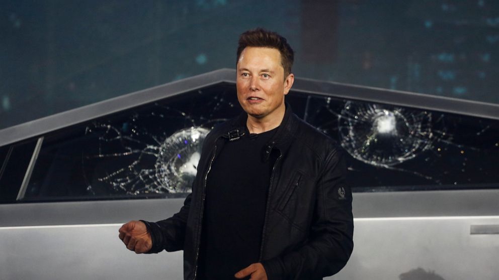 FILE - In this Nov. 21, 2019 file photo, Tesla CEO Elon Musk introduces the Cybertruck at Tesla's design studio in Hawthorne, Calif. Musk is taking on the workhorse heavy pickup truck market with his latest electric vehicle. The much-hyped unveil of 