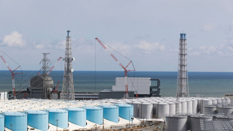 FILE - The Pacific Ocean looks over nuclear reactor units of No. 3, left, and 4 at the Fukushima Daiichi nuclear power plant in Okuma town, Fukushima prefecture, northeastern Japan on Feb. 27, 2021. A team from the U.N. nuclear agency arrived in Japa