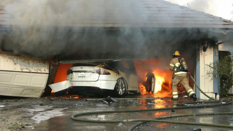 This undated photo provided by National Transportation Safety Board, The Orange County Fire Authority battles a fire on a burning vehicle inside a garage in Orange County, Calif. When firefighters removed the SUV from the garage to assess the fire , 