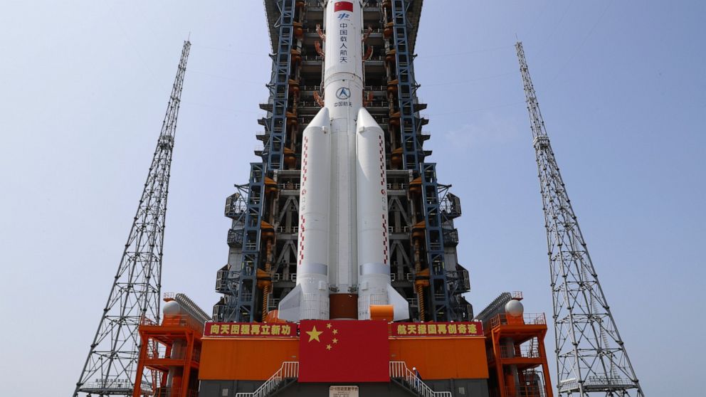 In this photo released by Xinhua News Agency, the core module of China's space station, Tianhe, on the the Long March-5B Y2 rocket is moved to the launching area of the Wenchang Spacecraft Launch Site in southern China's Hainan Province on April 23, 