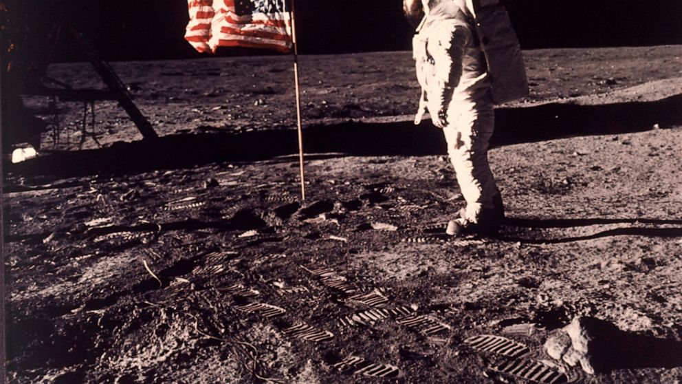 FILE - In this image provided by NASA, astronaut Buzz Aldrin poses for a photograph beside the U.S. flag deployed on the moon during the Apollo 11 mission on July 20, 1969. A new poll shows most Americans prefer focusing on potential asteroid impacts
