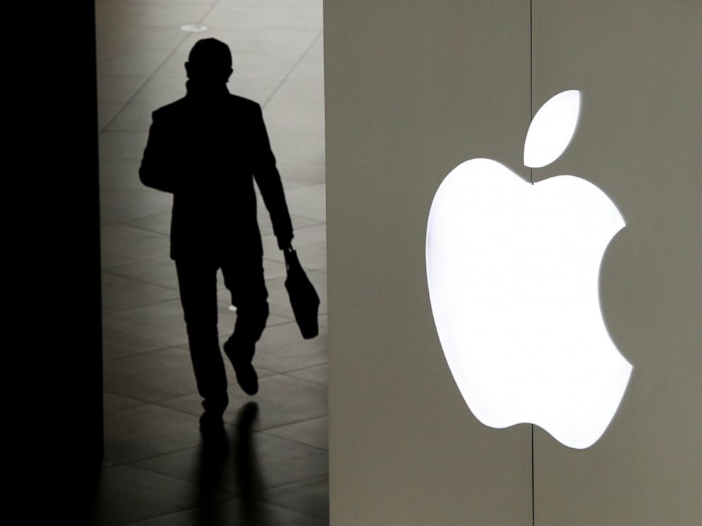 FILE- In this Jan. 3, 2019, file photo a man leaves an Apple store in Beijing. A trade court judge will recommend banning some iPhones from being imported into the U.S. after concluding Apples best-selling device infringed on technology owned by mob