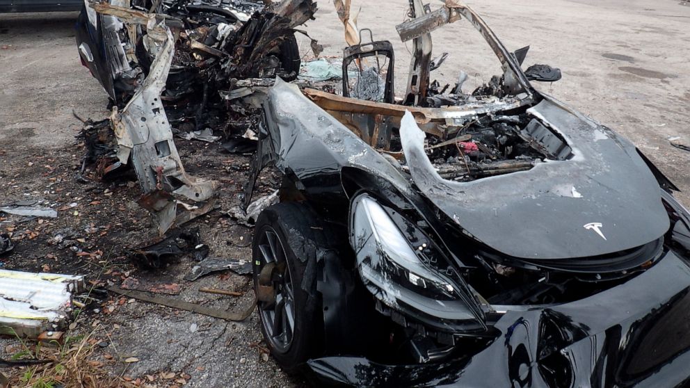 This image provided by the National Transportation Safety Board shows damage to a 2021 Tesla Model 3 Long Range Dual Motor electric car following a crash in September, 2021, in Coral Gables, Fla. The Tesla driver who died with a passenger in a fiery 