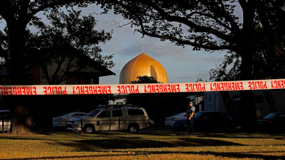 FILE - In this March 17, 2019, file photo a police officer stands guard in front of the Masjid Al Noor mosque in Christchurch, New Zealand, where one of two mass shootings occurred. Facebook will work with law enforcement organizations to train its m