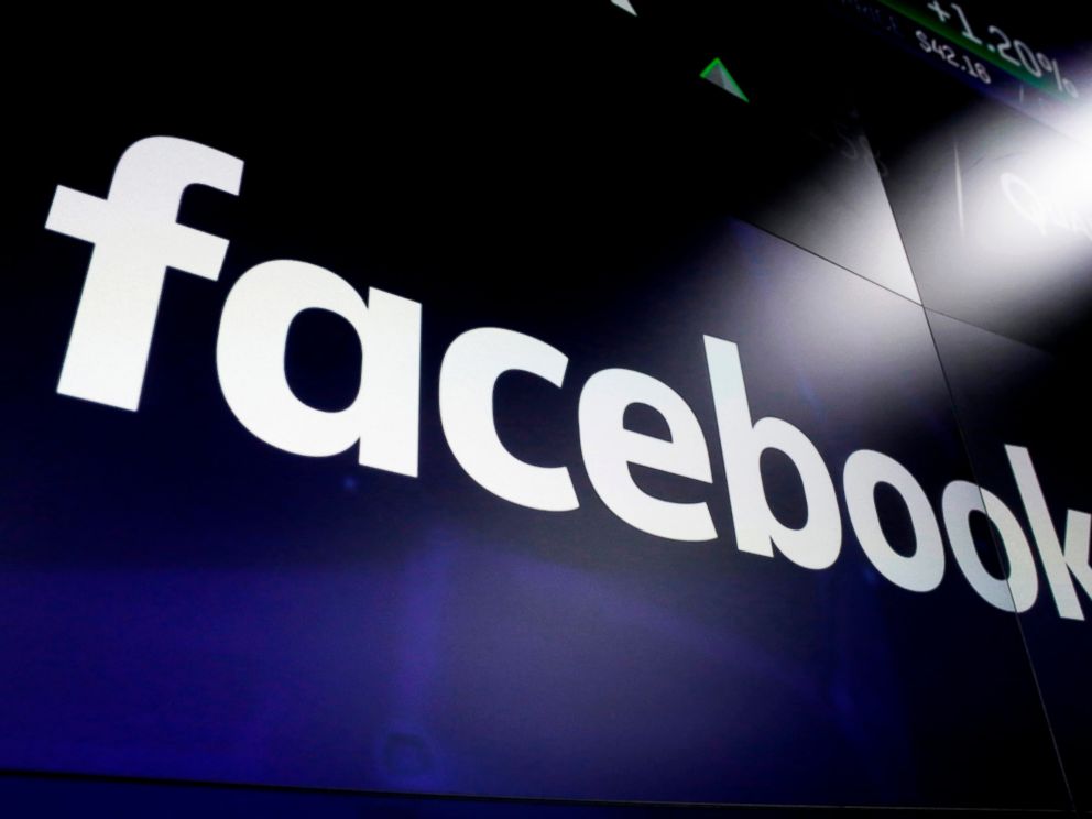 FILE - In this March 29, 2018, file photo, the logo for Facebook appears on screens in New Yorks Times Square. The New York Times reports Wednesday, March 13, 2019, that federal prosecutors are conducting a criminal investigation into Facebooks dat