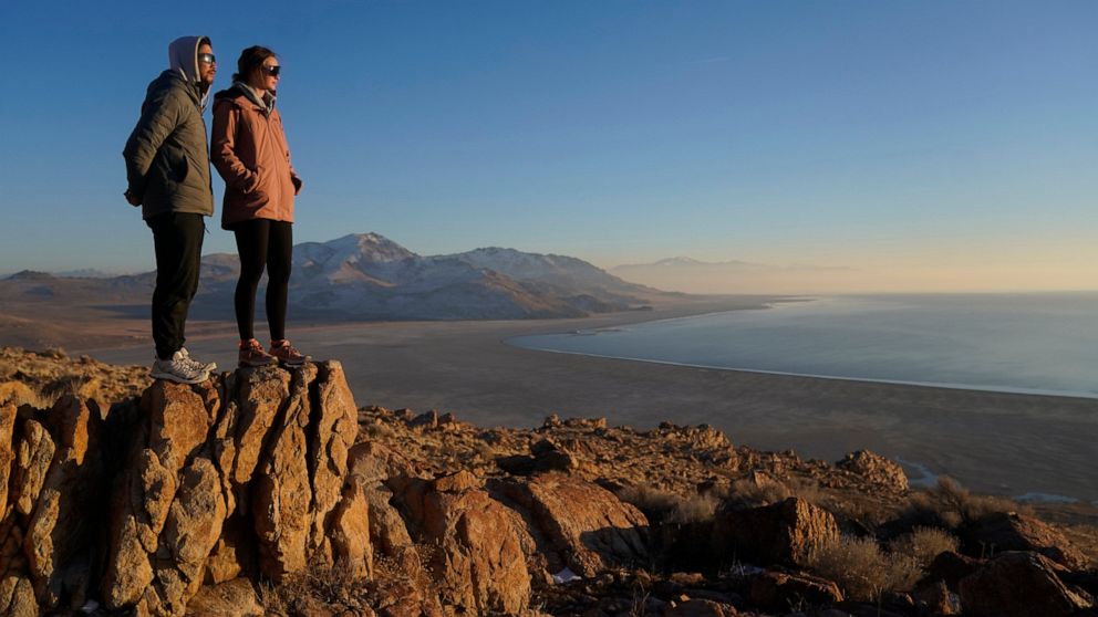 Antelope Island State Park visitors view the the receding edge of the Great Salt Lake Friday, Jan. 28, 2022, at Antelope Island, Utah. The largest natural lake west of the Mississippi is shrinking past its lowest levels in recorded history, raising f