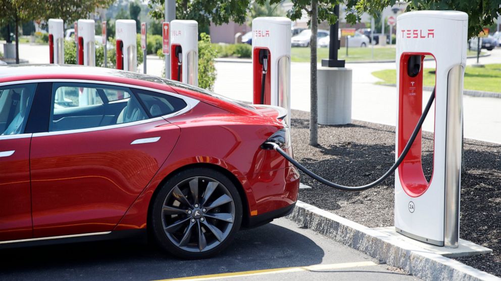 FILE - A Tesla Model S is plugged in at a vehicle Supercharging station in Seabrook, N.H., Aug. 24, 2018. The driver of a Tesla operating on autopilot must stand trial for a crash that killed two people in a Los Angeles suburb, a judge ruled Thursday