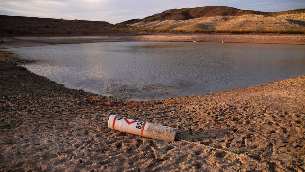 FILE - A buoy rests on the ground at a closed boat ramp on Lake Mead at the Lake Mead National Recreation Area near Boulder City, Nev., on Aug. 13, 2021. To help stave off another round of mandatory cutbacks, water leaders for Arizona, Nevada and Cal