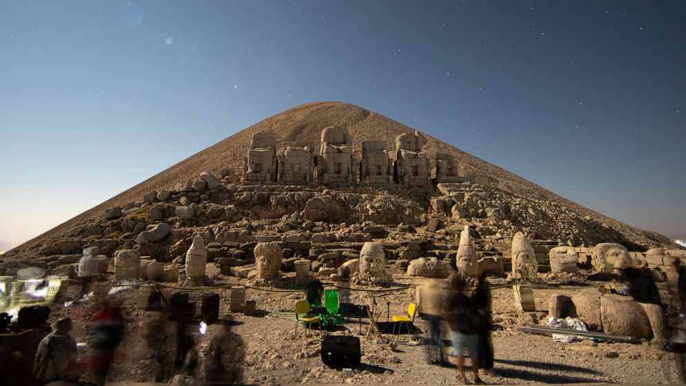 Stargazers gather to watch the Perseid meteor shower among ancient statues atop Mount Nemrut in southeastern Turkey, Saturday, Aug. 13, 2022. Hundreds spent the night at the UNESCO World Heritage Site for the annual meteor show that stretches along t