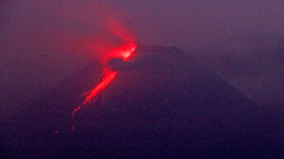 In this photo taken using slow camera shutter speed, hot lava runs down from the crater of Mount Merapi, in Sleman, Yogyakarta, Indonesia, early Monday, Aug. 9, 2021. Indonesia's most volatile volcano on the densely populated island of Java was erupt