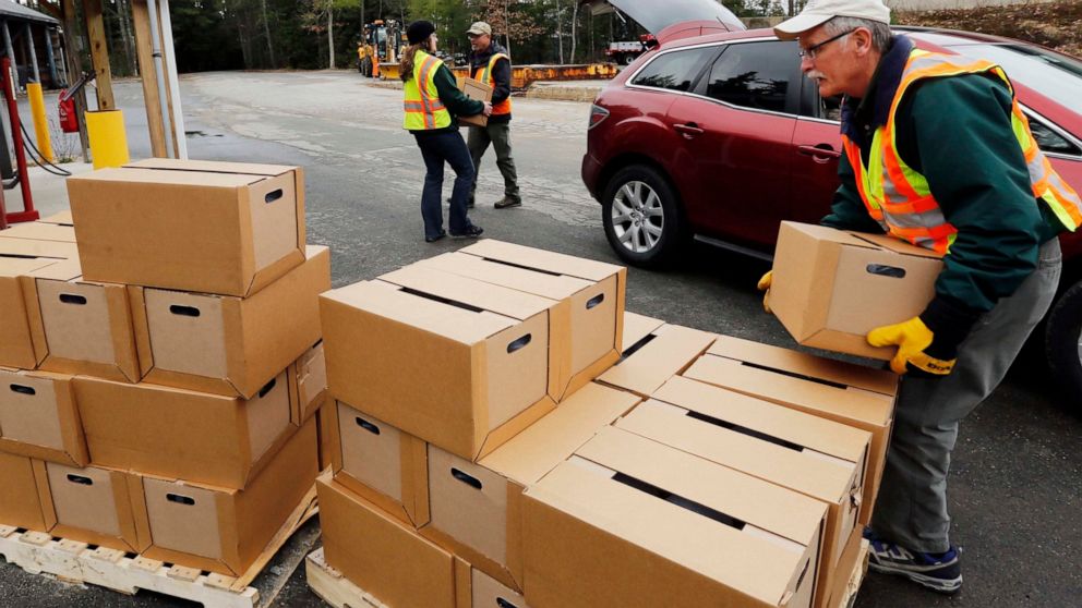 FILE - In this Monday, April 11, 2016 file photo, New Hampshire state and local officials load boxes of free bottled water in in Litchfield, N.H. New Hampshire is suing eight companies including 3M and Dupont for damage it says has been caused statew