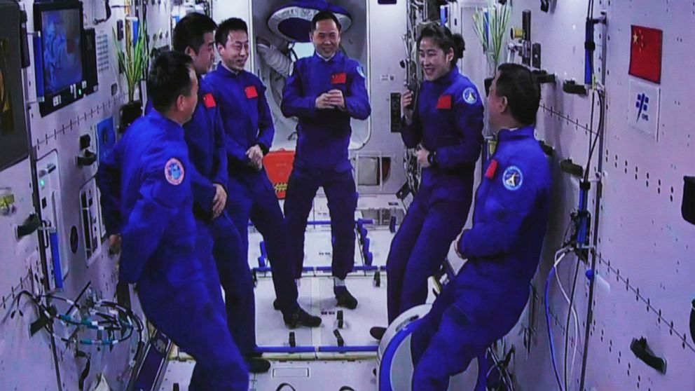 In this photo released by Xinhua News Agency, an image captured off a screen at the Jiuquan Satellite Launch Center in northwest China shows the Shenzhou-15 and Shenzhou-14 crew chatting after a historic gathering in space on Wednesday, Nov. 30, 2022