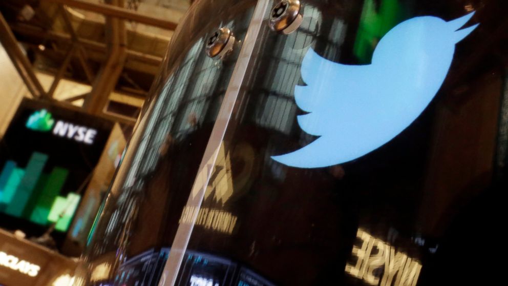 FILE - In this Nov. 6, 2013 file photo, the Twitter bird logo is on an updated phone post on the floor of the New York Stock Exchange. Social media company Twitter says Tuesday Feb. 19, 2019, it is tightening up rules for European Union political ads