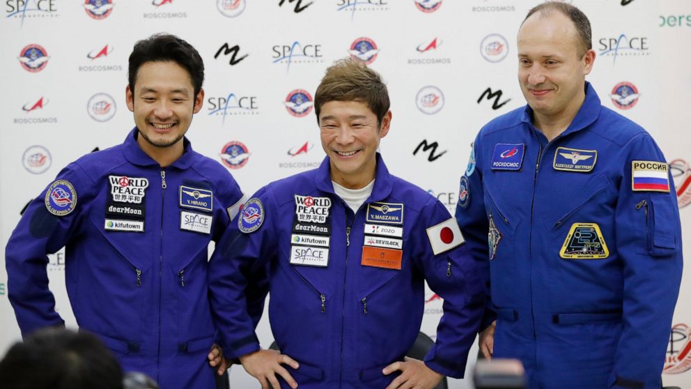 FILE - Roscosmos cosmonaut Alexander Misurkin, right, space flight participants Yusaku Maezawa, center, and Yozo Hirano attend a news conference ahead of the expedition to the International Space Station at the Gagarin Cosmonauts' Training Center in 