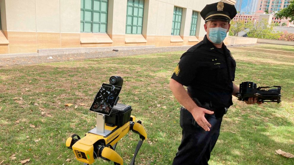 Honolulu Police Acting Lt. Joseph O’Neal demonstrates a robotic dog in Honolulu, Friday May 14, 2021. Police officials experimenting with the four-legged machines say they’re just another tool, like drones or simpler wheeled robots, to keep emergency