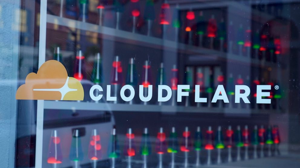 Lava lamps are seen through a lobby window at the headquarters of Cloudflare in San Francisco, Wednesday, Aug. 31, 2022. Citing “imminent danger,” Cloudflare has dropped the notorious stalking and harassment site Kiwi Farms from its internet security