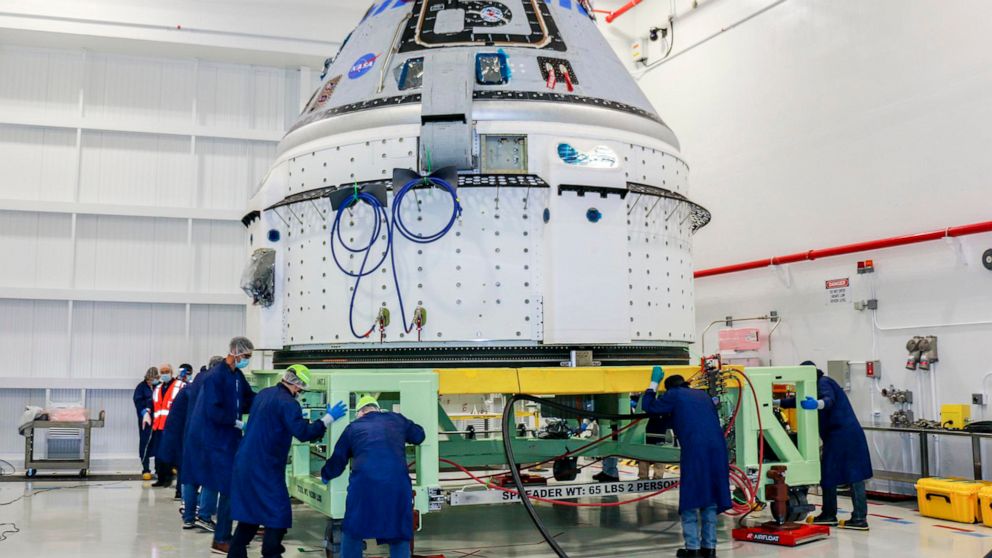 In this June 2, 2021 photo made available by NASA, technicians prepare Boeing's CST-100 Starliner for the company's Orbital Flight Test-2 (OFT-2) in the Commercial Crew and Cargo Processing Facility at NASA's Kennedy Space Center in Florida. On Frida