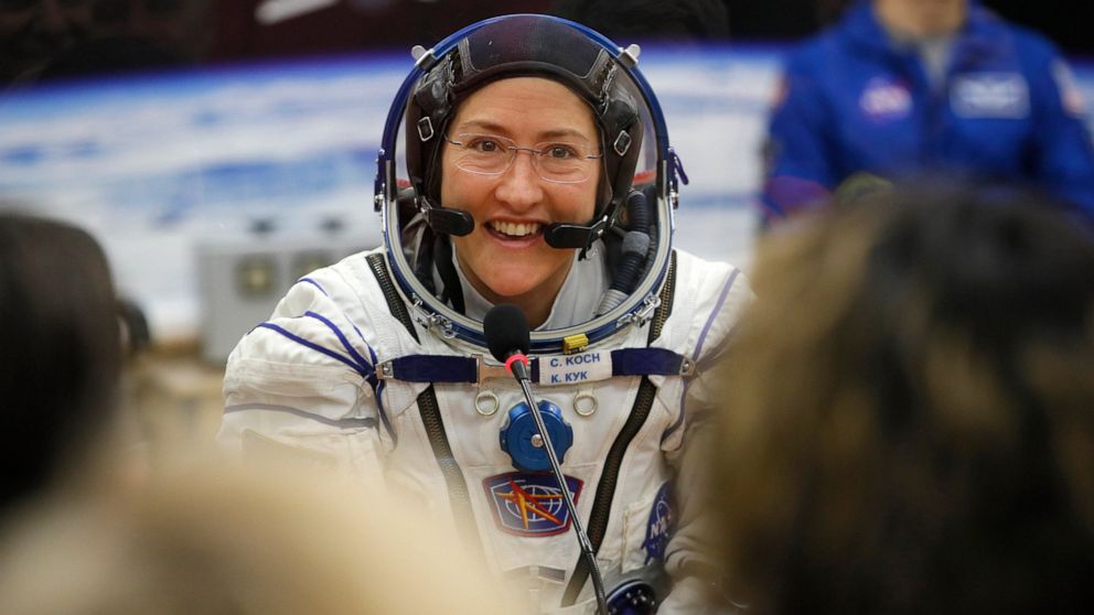 FILE - In this Thursday, March 14, 2019 file photo, U.S. astronaut Christina Koch, member of the main crew of the expedition to the International Space Station (ISS), speaks with her relatives through a safety glass prior the launch of Soyuz MS-12 sp