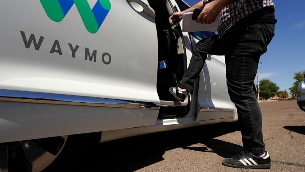 FILE - In this April 7, 2021 file photo, a Waymo minivan arrives to pick up passengers for an autonomous vehicle ride, in Mesa, Ariz. Waymo, the Google self-driving vehicle spinoff, is moving to expand its autonomous ride-hailing service to San Franc