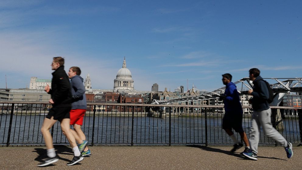 FILE - In this file photo dated Sunday, March 22, 2020, people run to keep fit along the south bank of the River Thames in London. European Union regulators have said Tuesday Aug, 4, 2020, they're opening an in-depth investigation into U.S. tech gian