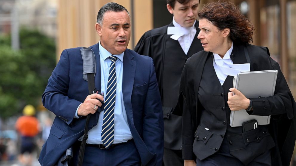 Former New South Wales Deputy Premier John Barilaro, left, arrives at the The Federal Court of Australia in Sydney on March 23, 2022. An Australian court on Monday ordered Google to pay a former politician 715,000 Australian dollars ($515,000) over t