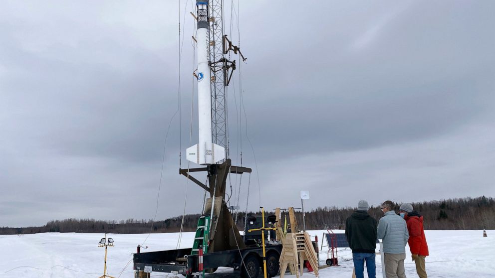 Members of bluShift Aerospace prepare for a test launch of a 20-foot rocket prototype, Thursday, Jan. 14, 2021, in Limestone, Maine. The company hopes to eventually use similar rockets to launch small satellites. (Betta Stothart via AP)